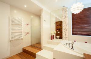 Main large bathroom showing bath, mirror and separate shower.